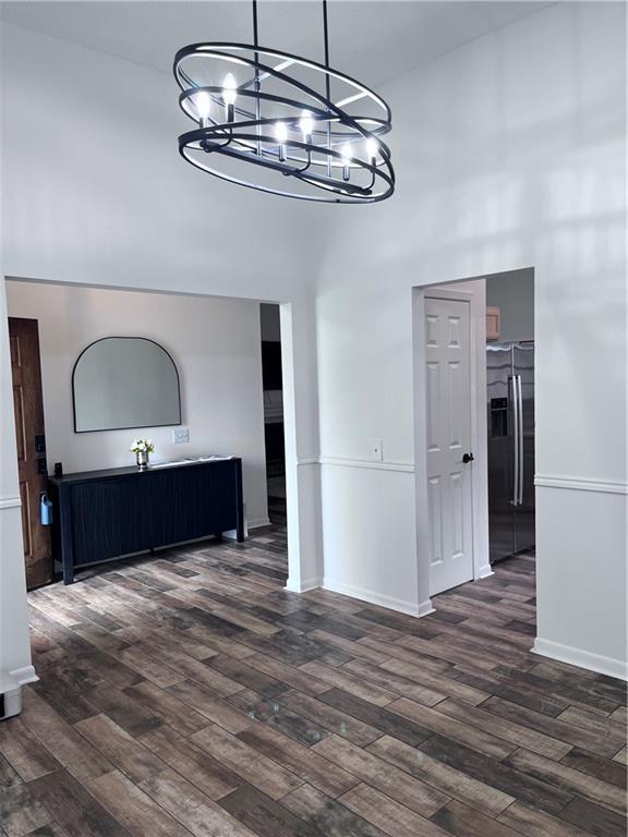 kitchen with dark hardwood / wood-style floors, sink, stainless steel dishwasher, and light brown cabinetry