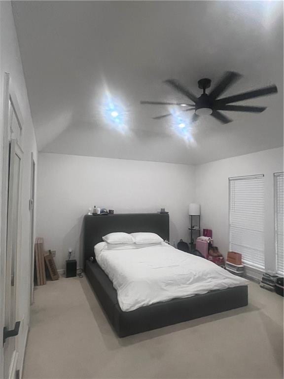 bedroom featuring ceiling fan and light carpet