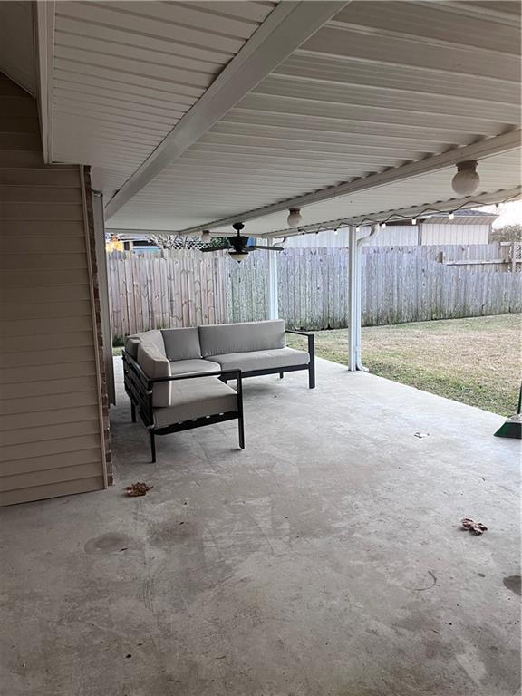 2261 Country Club Dr, La Place, LA 70068 - view of patio featuring an outdoor hangout area and fence