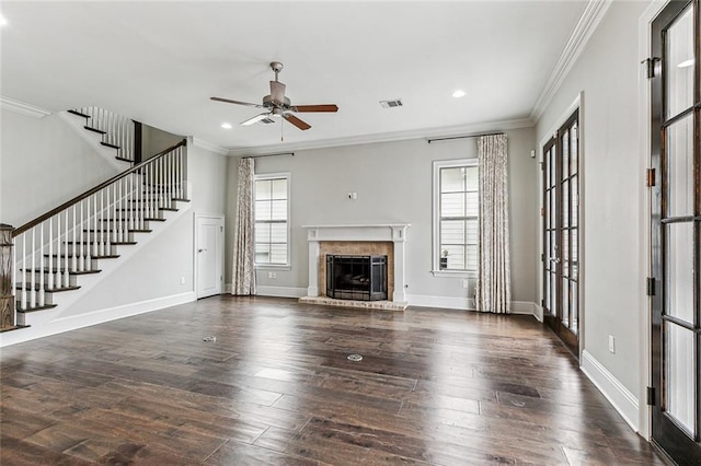 unfurnished living room with ornamental molding, a healthy amount of sunlight, and dark wood-type flooring