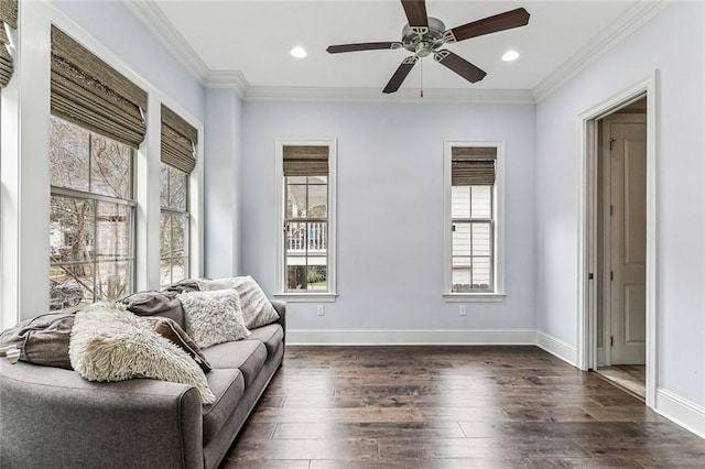 living room with crown molding, ceiling fan, and dark hardwood / wood-style floors