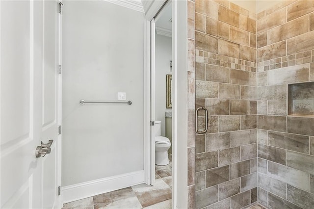 bathroom featuring crown molding, an enclosed shower, and toilet