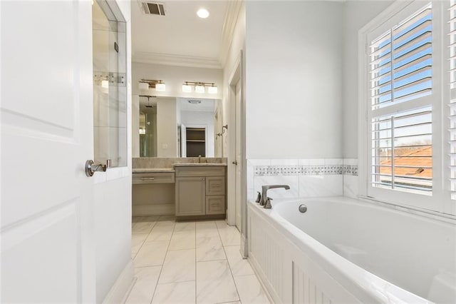 bathroom featuring vanity, a healthy amount of sunlight, crown molding, and a tub to relax in