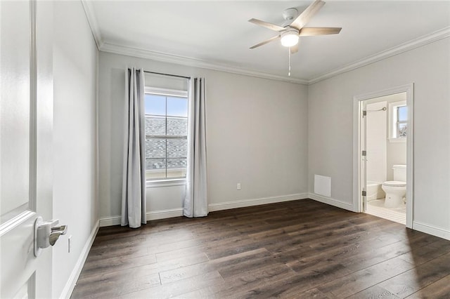 unfurnished bedroom featuring connected bathroom, dark wood-type flooring, ornamental molding, and ceiling fan