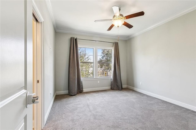 carpeted empty room featuring ornamental molding and ceiling fan