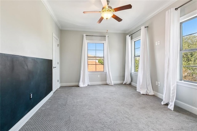 carpeted spare room with crown molding and ceiling fan