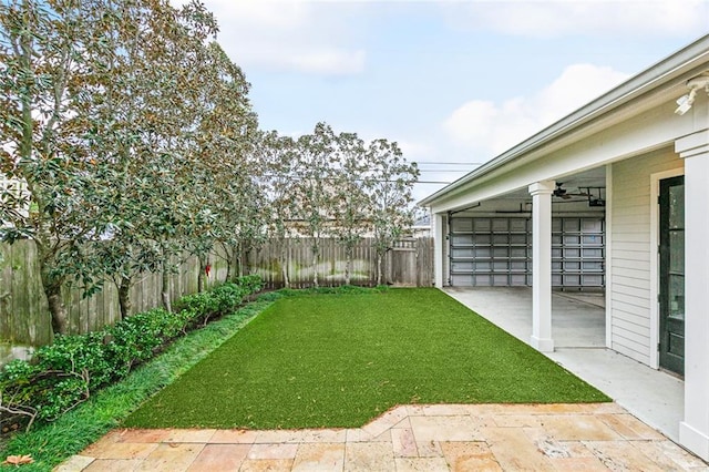 view of yard featuring a patio and ceiling fan