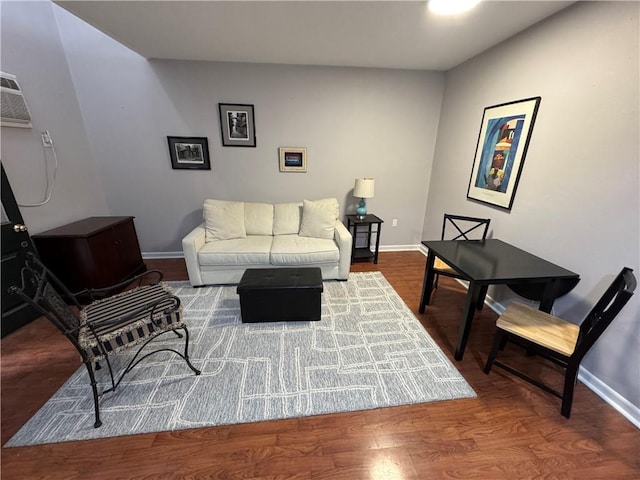 living room with hardwood / wood-style floors and a wall unit AC