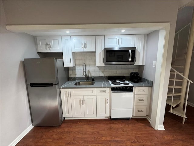 kitchen with stainless steel appliances, sink, and white cabinets