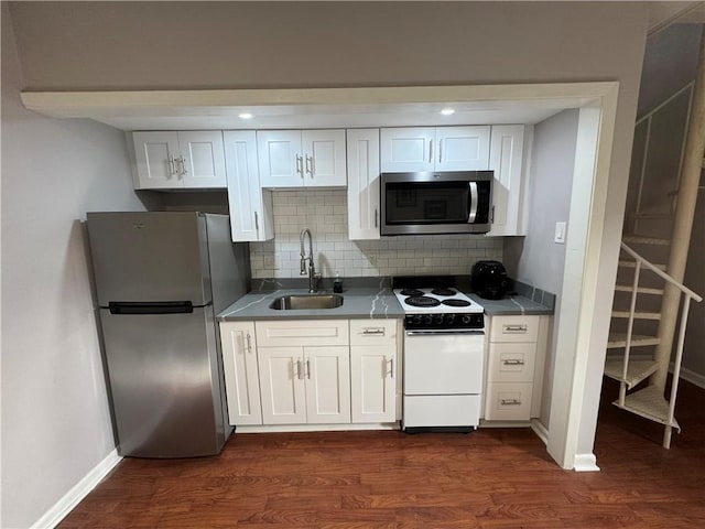 1119 Dauphine St Unit 11, New Orleans, LA 70116 - kitchen with stainless steel appliances, a sink, baseboards, and white cabinetry