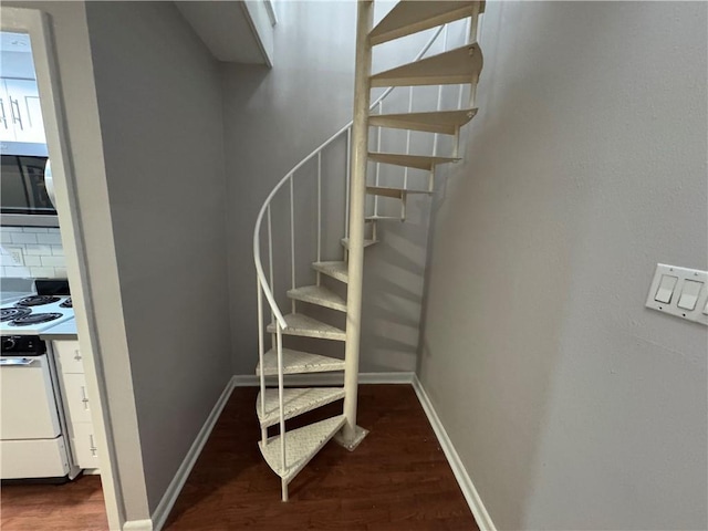 stairs featuring hardwood / wood-style floors