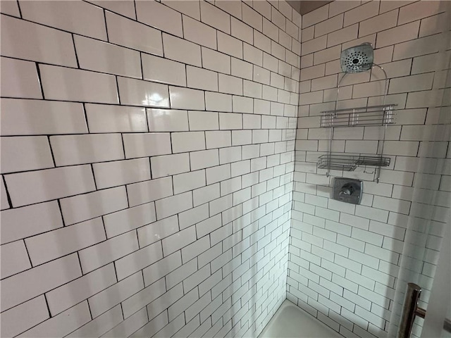 bathroom with tiled shower