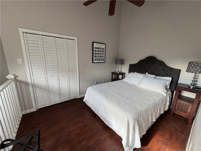 bedroom with dark hardwood / wood-style floors, a closet, and ceiling fan