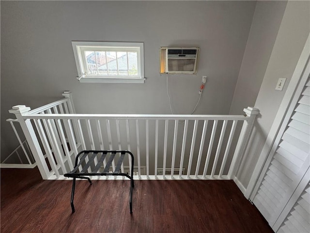 stairs featuring hardwood / wood-style flooring and a wall mounted AC