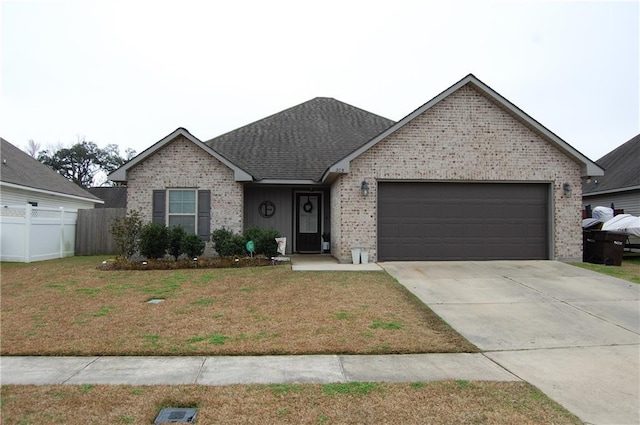 ranch-style house with a garage and a front yard