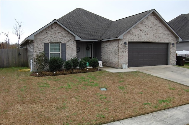 view of front of property featuring a garage and a front yard