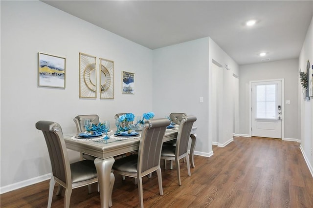 dining space with wood-type flooring