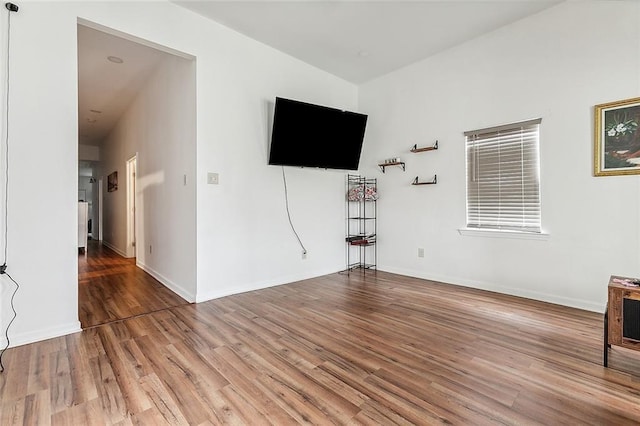 unfurnished living room with wood-type flooring