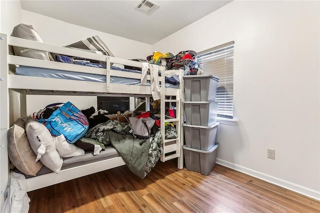 bedroom with hardwood / wood-style flooring