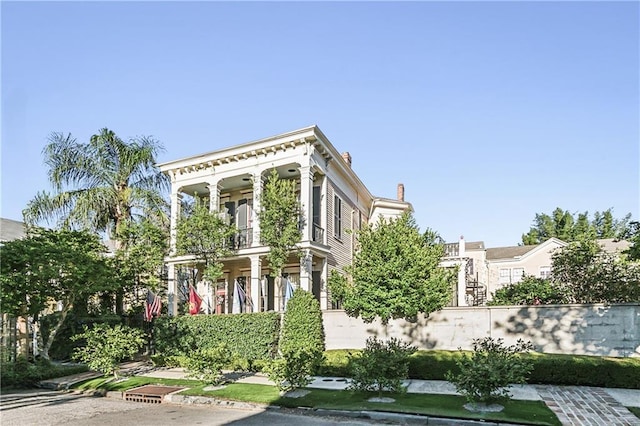 view of front of house featuring a balcony