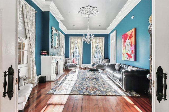 living room with ornamental molding, dark hardwood / wood-style floors, and a chandelier