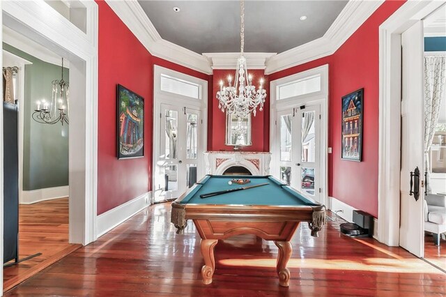 rec room featuring hardwood / wood-style flooring, ornamental molding, pool table, and a chandelier