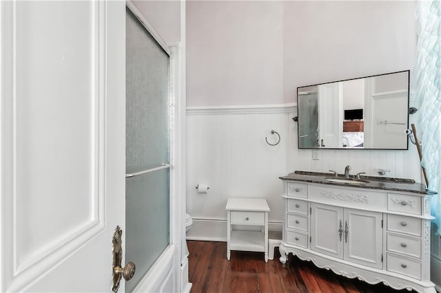 bathroom with hardwood / wood-style flooring, vanity, and toilet