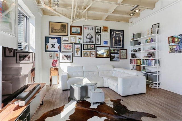 835 Julia St Unit 18, New Orleans, LA 70113 - living area with wood finished floors and beamed ceiling