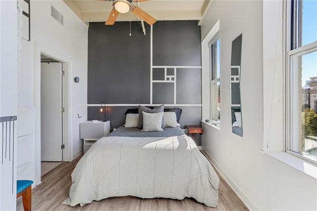 835 Julia St Unit 18, New Orleans, LA 70113 - bedroom with wood finished floors and a ceiling fan