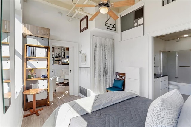 835 Julia St Unit 18, New Orleans, LA 70113 - bedroom with wood finished floors, a high ceiling, and baseboards