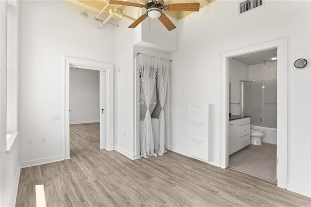 835 Julia St Unit 18, New Orleans, LA 70113 - spare room with light wood-type flooring, ceiling fan, and baseboards