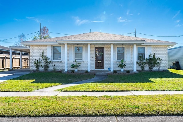 view of front facade with a carport and a front lawn