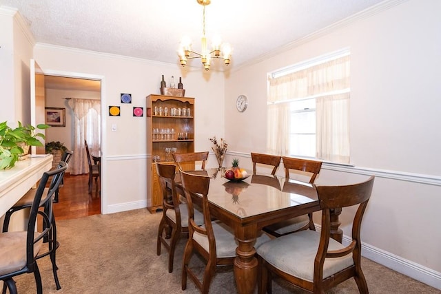 carpeted dining area featuring a notable chandelier, ornamental molding, and a textured ceiling