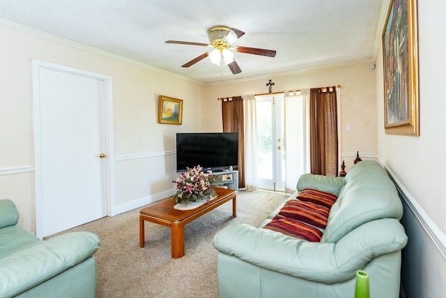 living room featuring crown molding, light colored carpet, and ceiling fan