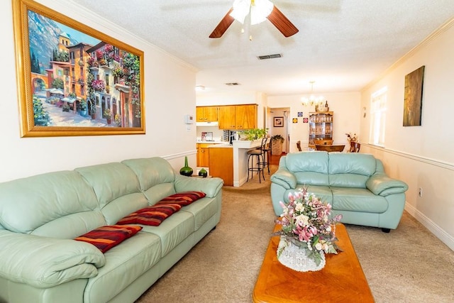 living room with ornamental molding, ceiling fan with notable chandelier, light colored carpet, and a textured ceiling