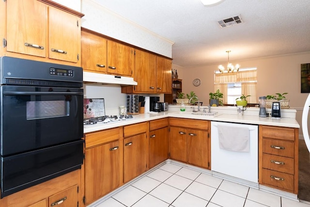 kitchen featuring pendant lighting, white appliances, kitchen peninsula, and sink