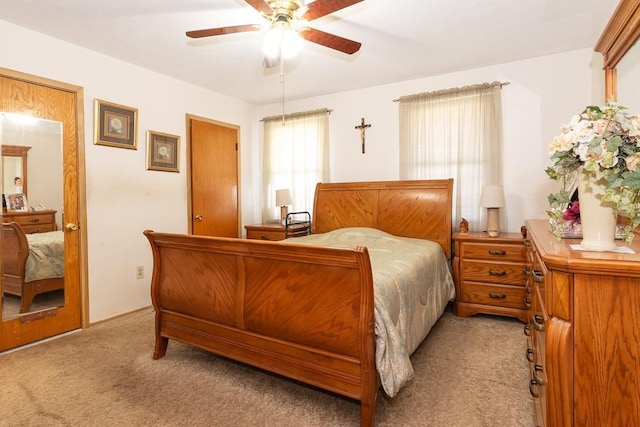 bedroom with light colored carpet and ceiling fan