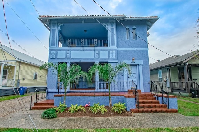 back of property with covered porch