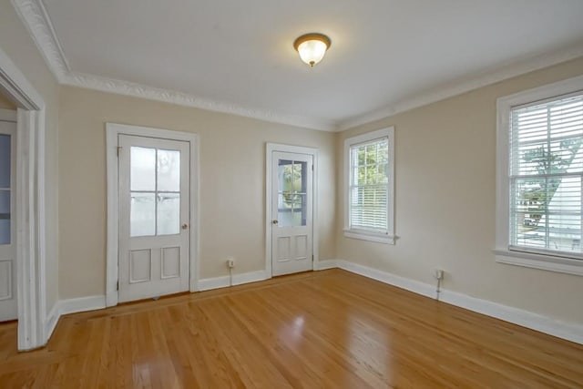 doorway to outside with hardwood / wood-style flooring, a healthy amount of sunlight, and ornamental molding