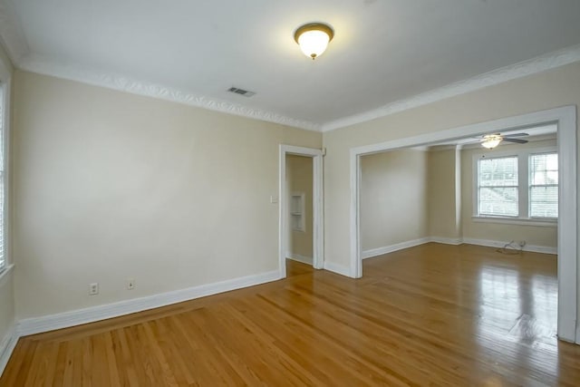 unfurnished room with hardwood / wood-style flooring and ornamental molding