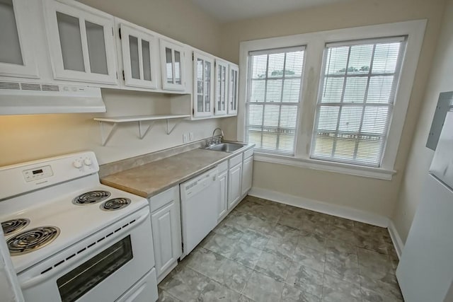 kitchen with sink, white cabinets, and white appliances