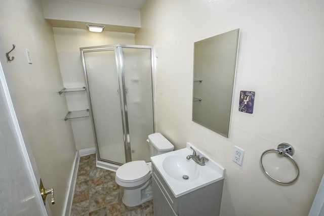 bathroom featuring vanity, an enclosed shower, and toilet