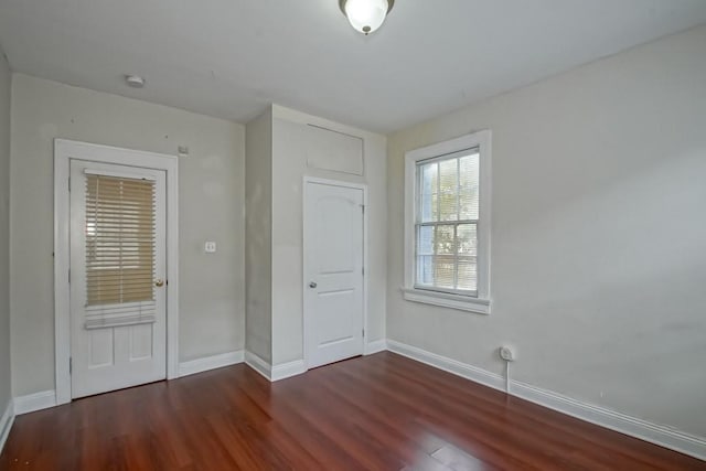 interior space with dark hardwood / wood-style floors and a closet