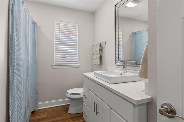 bathroom featuring hardwood / wood-style flooring, vanity, and toilet