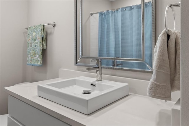 bathroom featuring vanity and a shower with shower curtain