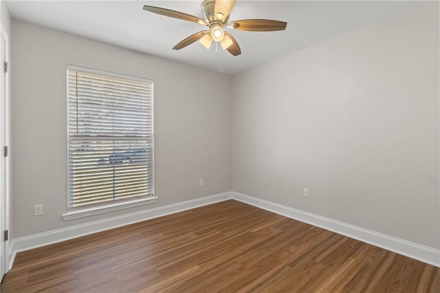 spare room with ceiling fan and dark hardwood / wood-style floors