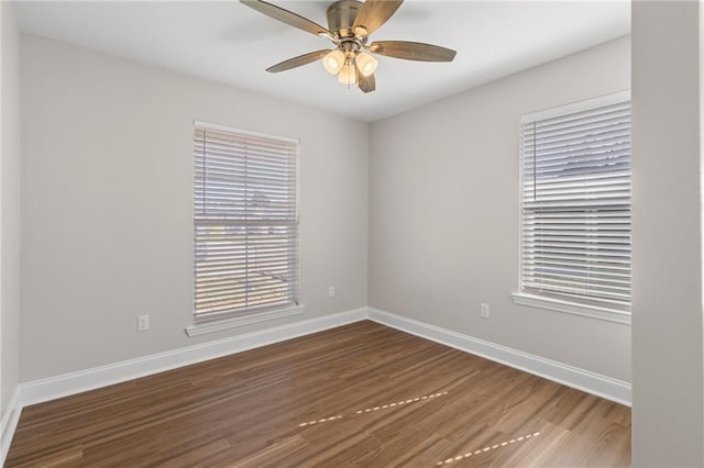 spare room featuring dark hardwood / wood-style flooring and ceiling fan