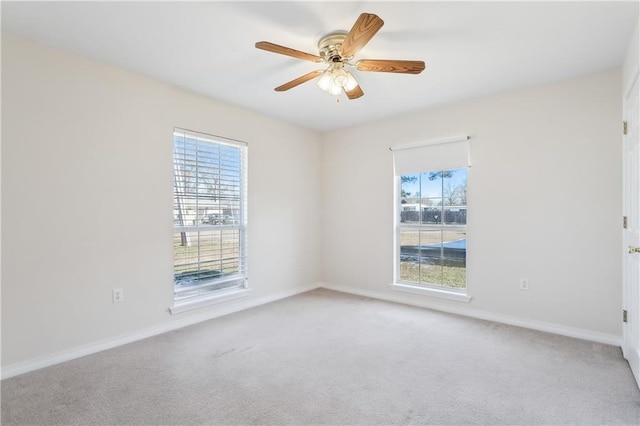 spare room with carpet and ceiling fan