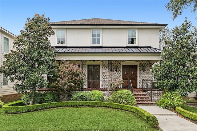 view of front of property featuring a front lawn and a porch