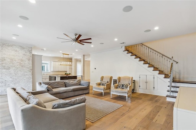 living room with crown molding and light hardwood / wood-style flooring